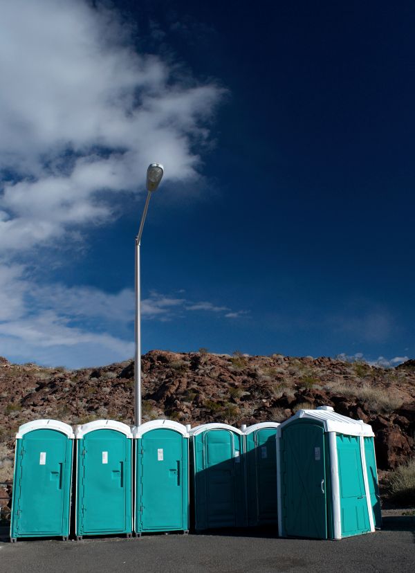 Porta potty delivery truck dropping off rental units in Bend
